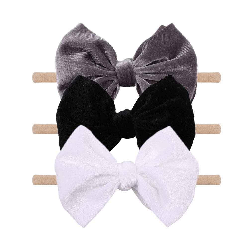 YanJie velvet bow on a black headband showing soft texture and gentle padding for newborns