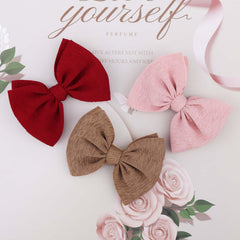 YanJie pink knotted bow headband for baby girls, soft stretch fits growing infants.