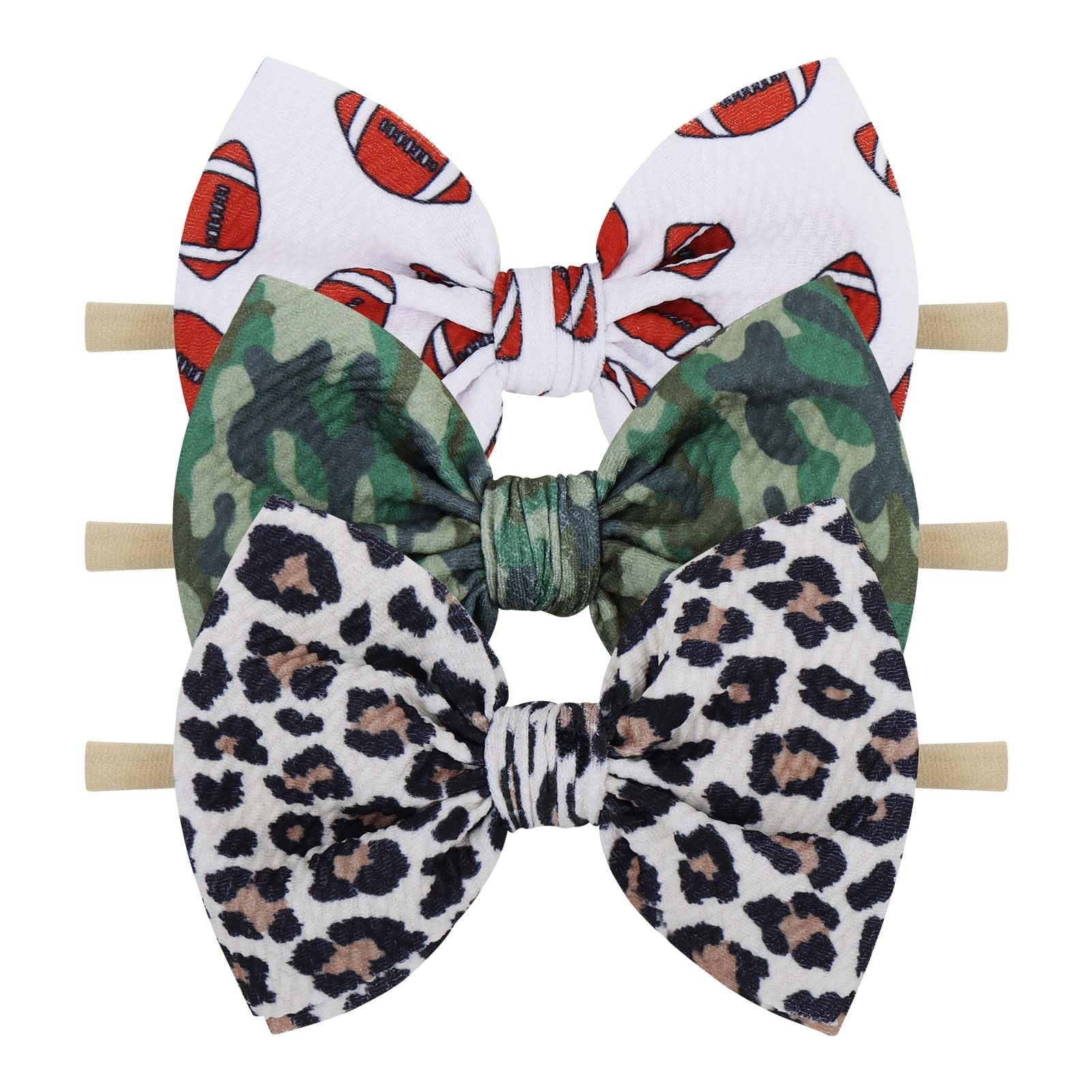 YanJie leopard-football-camo headband close-up showing adorable newborn styling