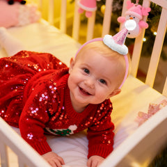YanJie mini Santa hat pink glitter headband shines during holiday photoshoots.
