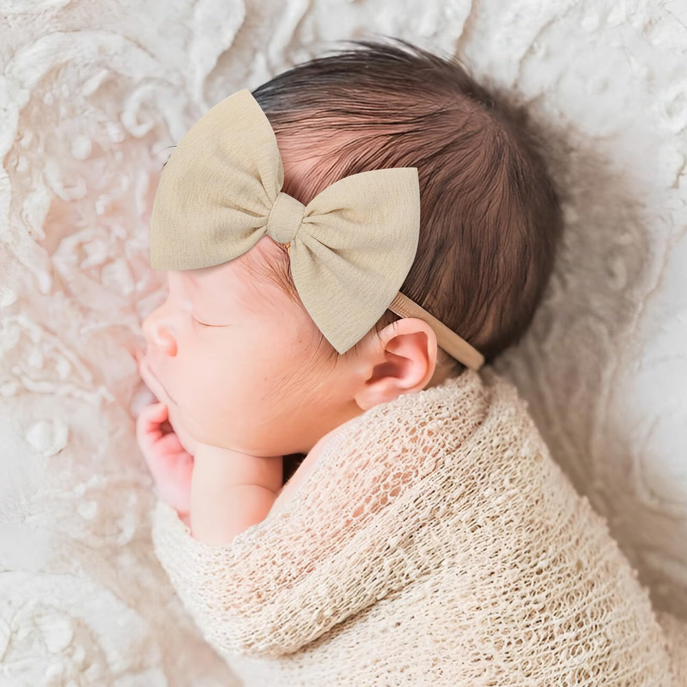 YanJie nylon headbands in pastel pink with a hand-tied bow for cute everyday outfits.