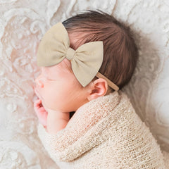 YanJie nylon headbands in pastel pink with a hand-tied bow for cute everyday outfits.