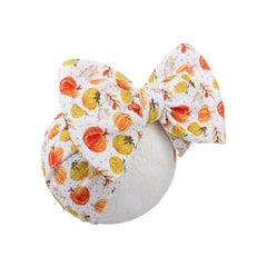 YanJie Pumpkin Headband with soft fabric on newborns for gentle daily wear.