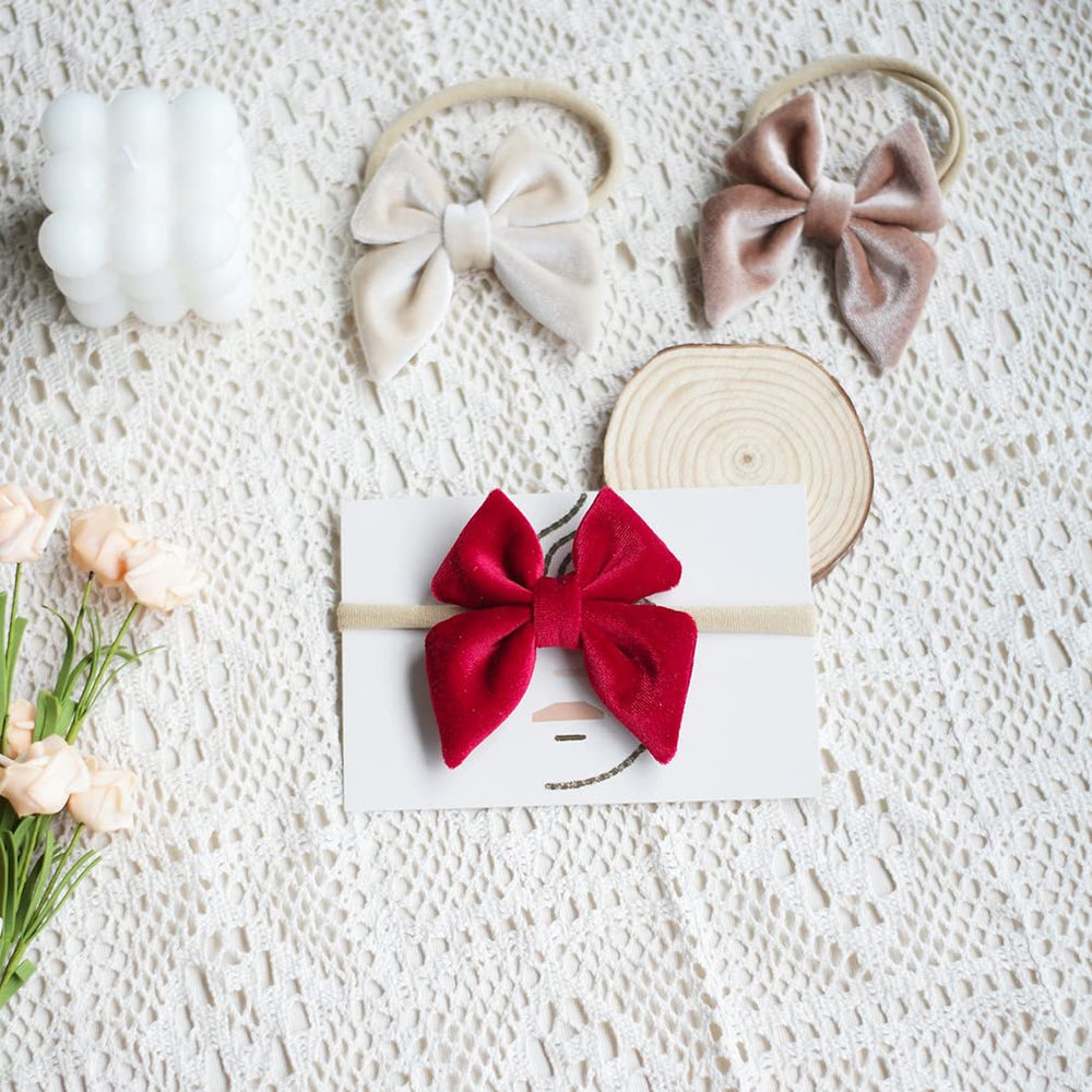 YanJie velvet bow headband in khaki showing stretchy band for growing child