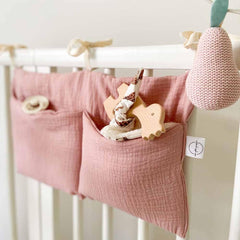 YeeMan cotton baby bedside hanging storage bag pink keeps diapers within reach.