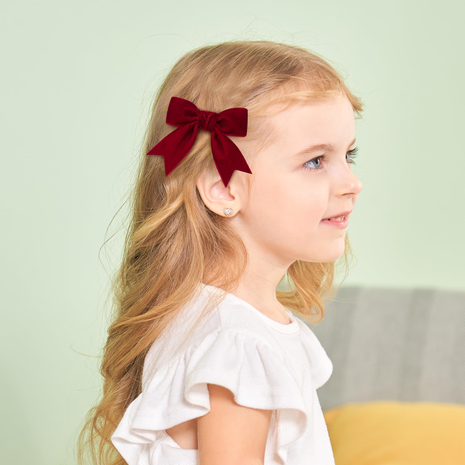 Yhlen velvet bow on toddler hairstyle showing gentle comfortable grip.
