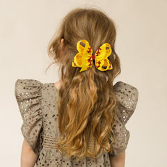 YHXX YLEN yellow bow on girl hair highlights easy pairing with uniforms.