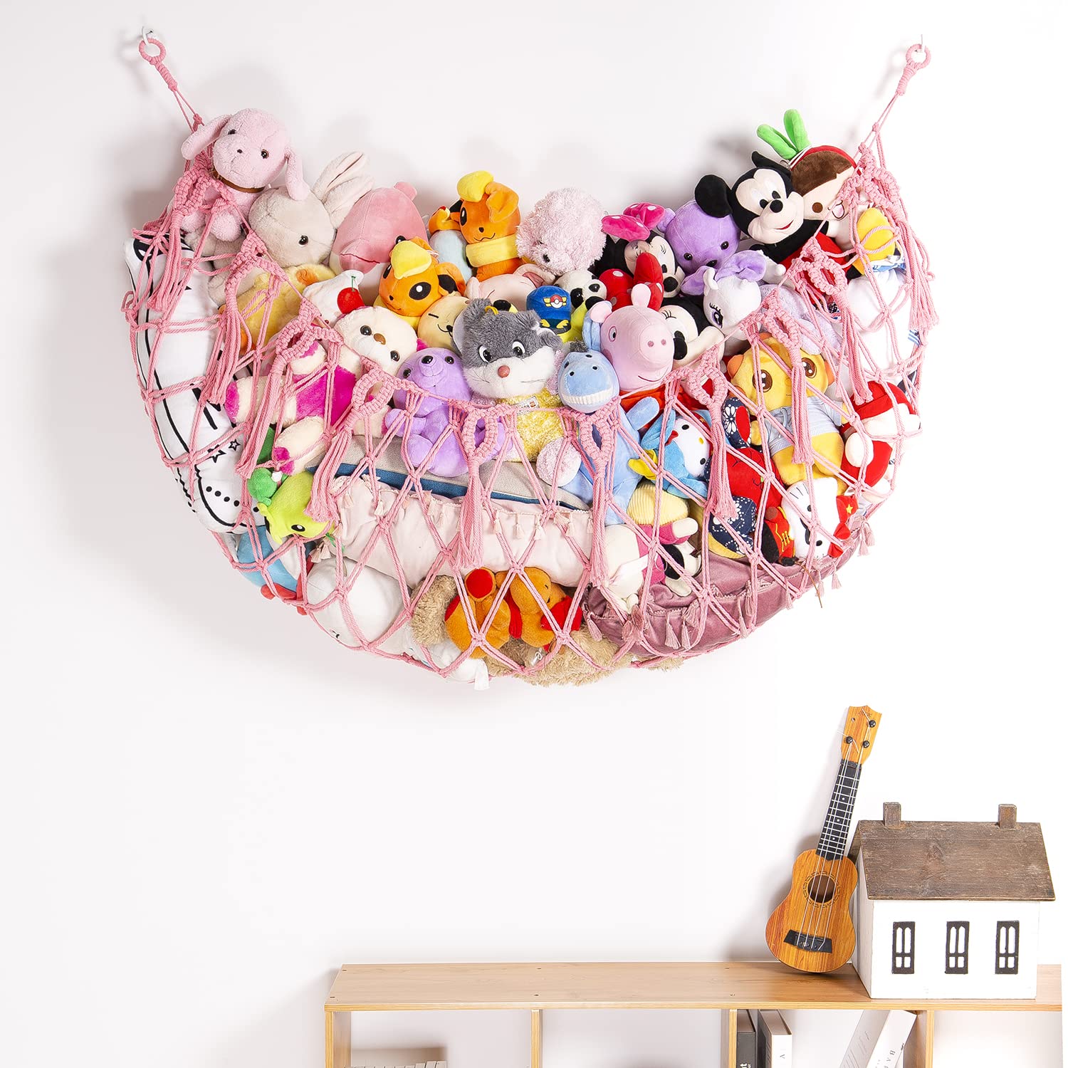 YKBU pink tassel hammock keeps toys organized and easy to access.