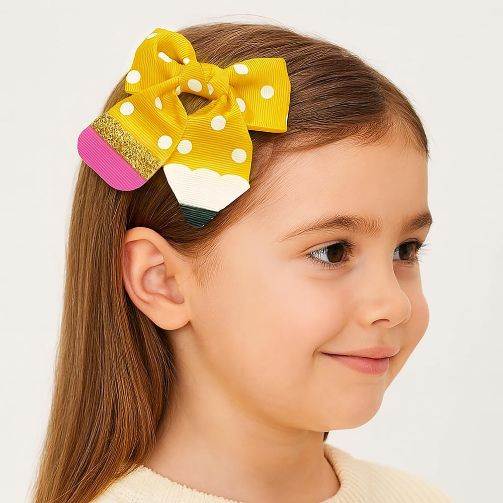 YKW Yellow Polka Dot Pencil Bow worn in hair—adds playful educational flair to outfits.