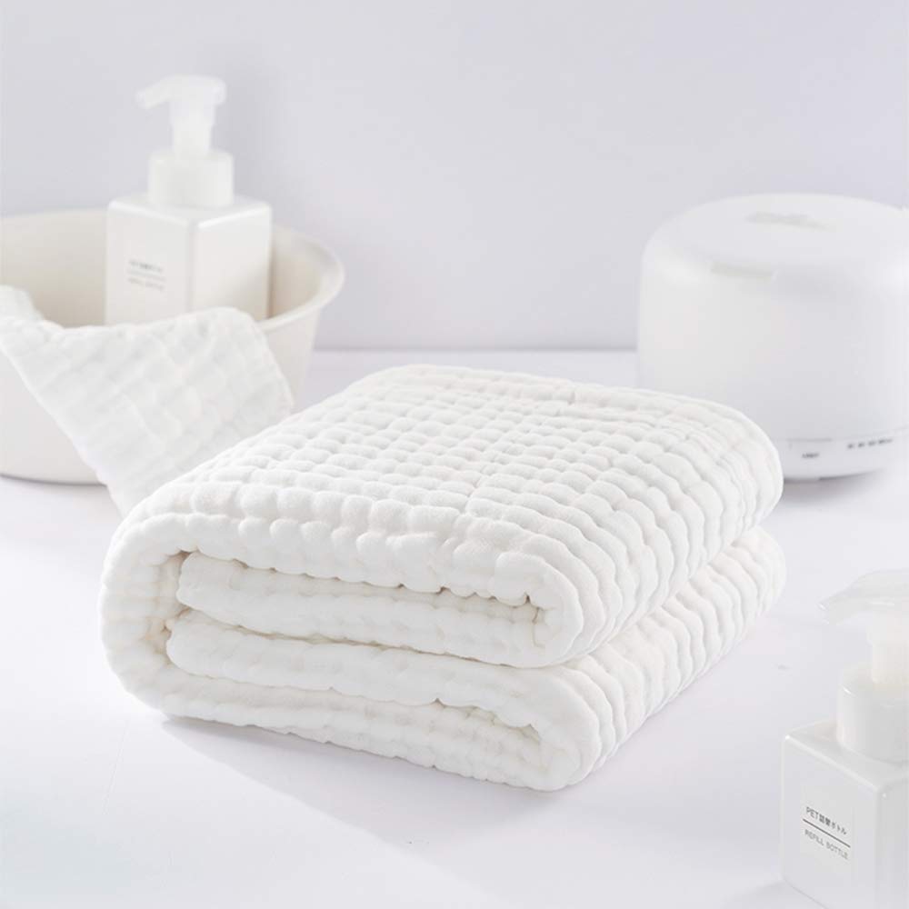 Yoofoss muslin cotton towel demonstrates absorbent surface for quick water pickup after baths.