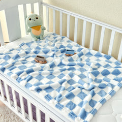 Yurhap checkered baby blanket blue in crib scene emphasizing warmth and breathable comfort.