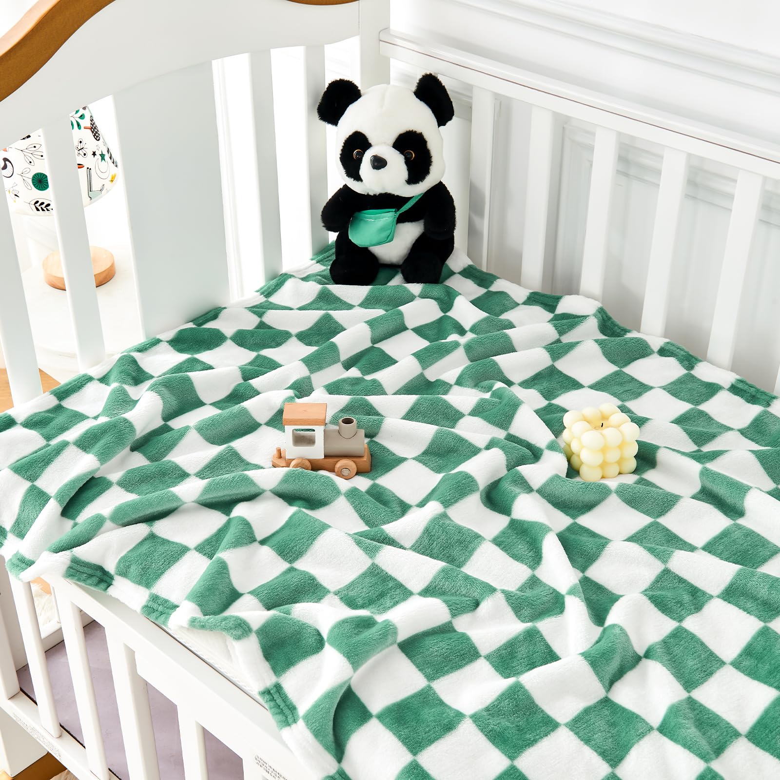 Yurhap checkered baby blanket crib scene highlights versatile swaddling and naps.