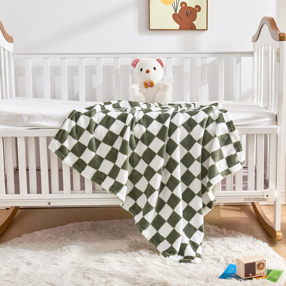 Yurhap checkered baby blanket in crib demonstrates stylish nursery accent