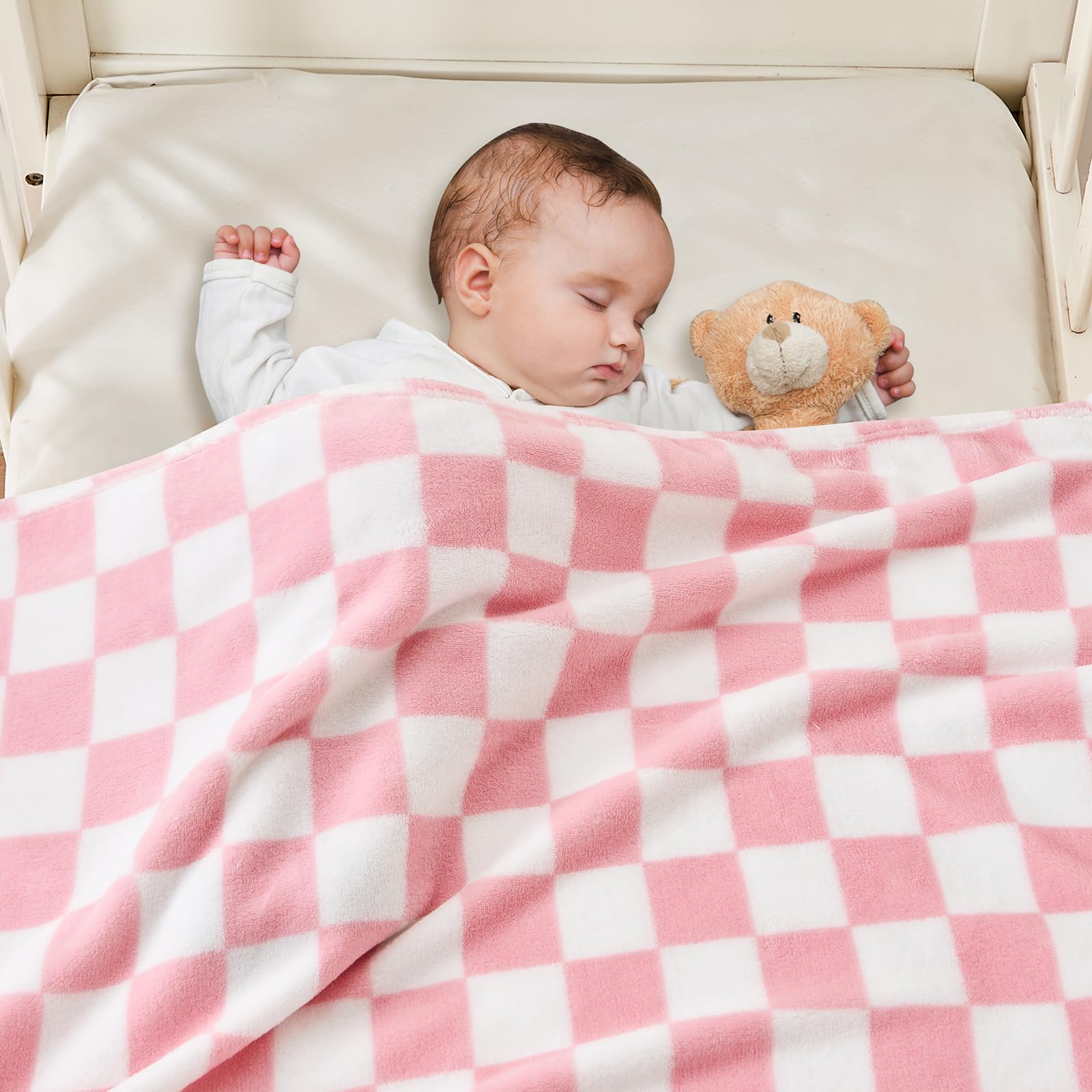Yurhap pink checkered baby blanket on baby, offering gentle warmth and comfort.