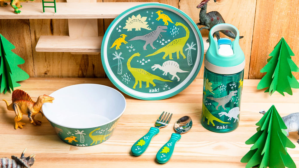Zak Designs dinosaur dinnerware kid-mealtime scene illustrates easy-grip utensils.