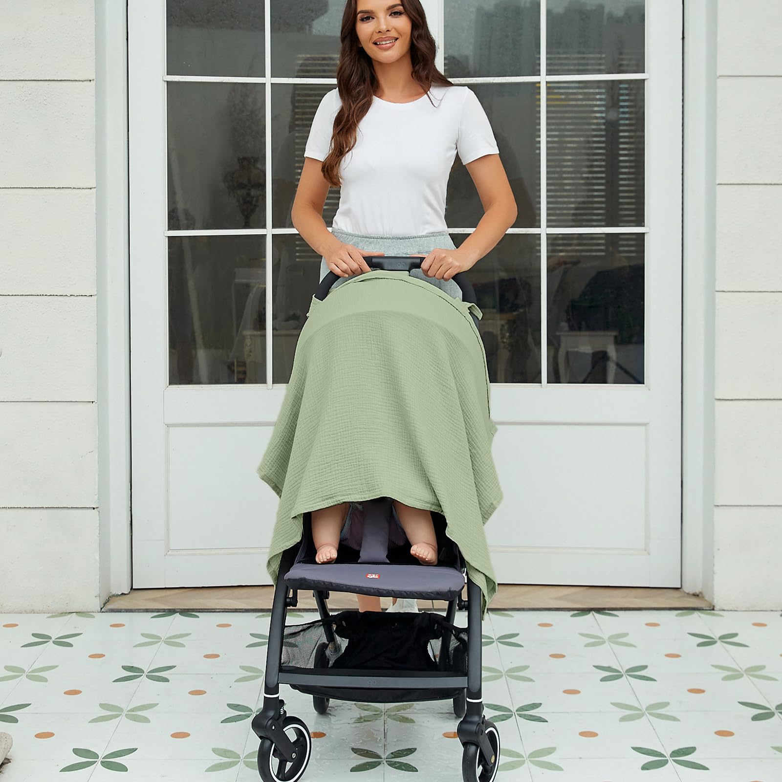 Zdolmy Sage-Green Muslin Nursing Cover doubles as stroller shade during walks.