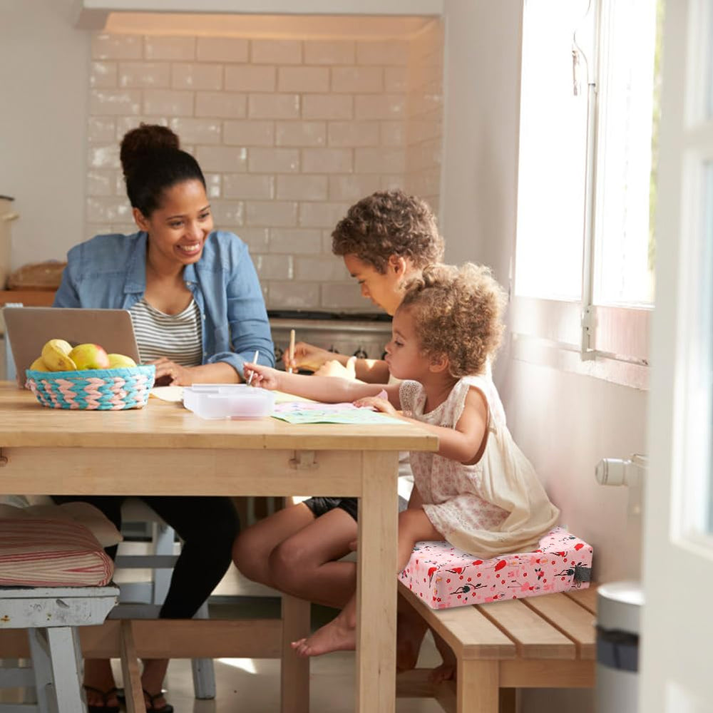 Zicac pink booster seat in-use demonstrates safe seating at table.