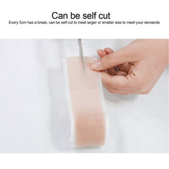 ZJchao ear corrector sticker being cut for customizable fit and gentle correction.