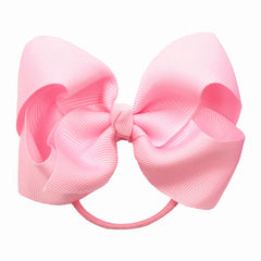ZOONAI 4-inch bow close-up highlighting gentle elastic grip for toddlers.