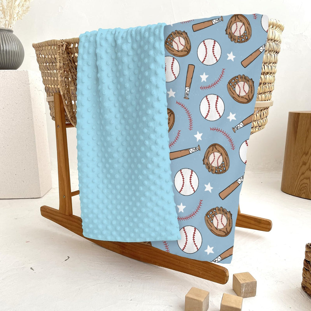 ZoUbqchY blue baseball baby blanket in crib showing cozy, secure sleep-ready layer.