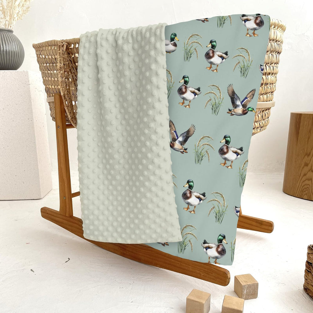 ZoUbqchY nursery-coordinated blanket complements matching crib sheets and rug.