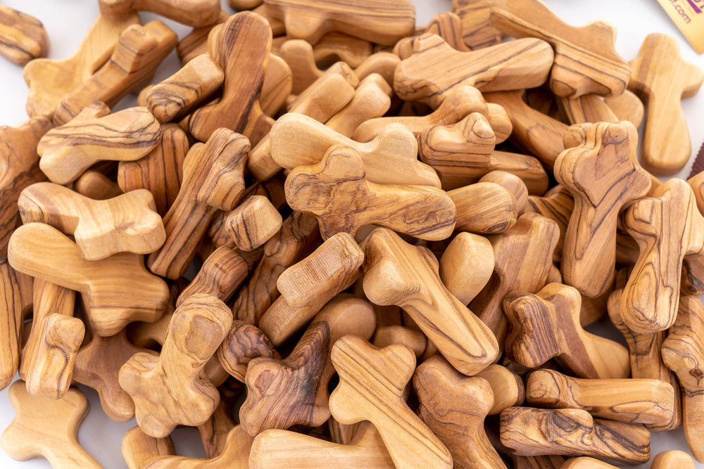 Zuluf olive wood cross in hand—portable devotion anywhere