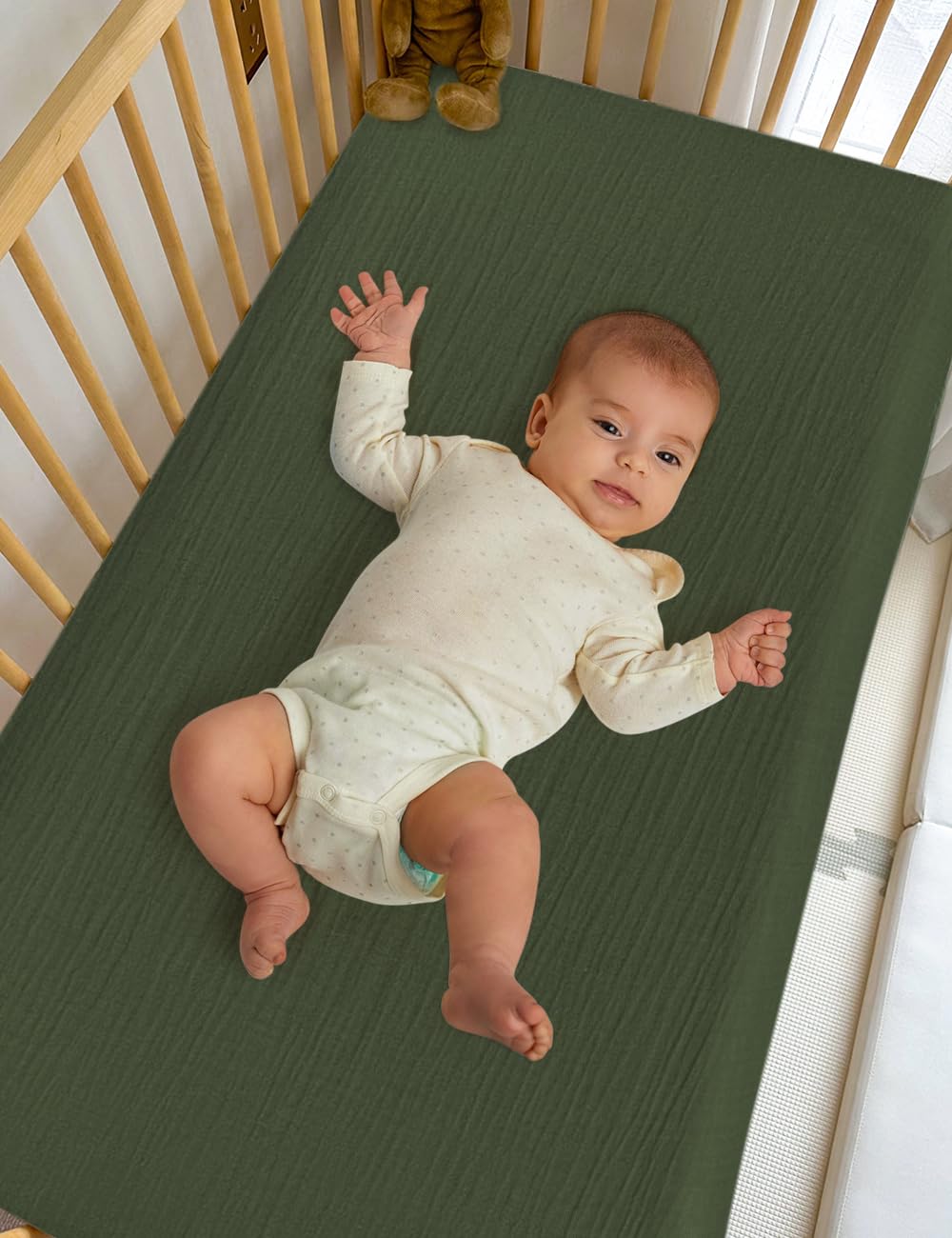 ZURLEFY olive green crib sheet folded—dense cotton for easy storage