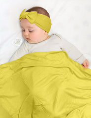 ZURLEFY Yellow swaddle headband worn with blanket for cute photos.